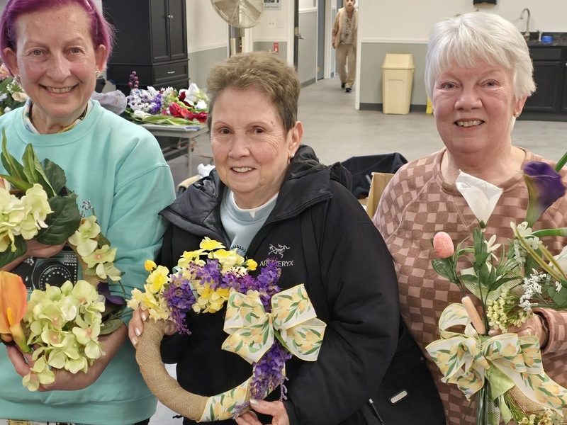 Members showing handmade wreaths they made in the craft group