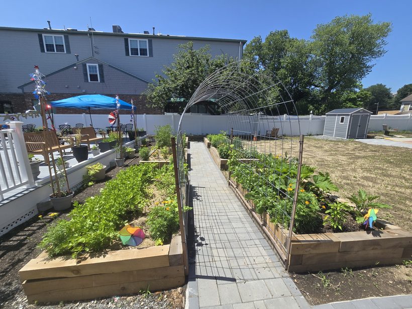 Raised garden beds full of vegetables and flowers