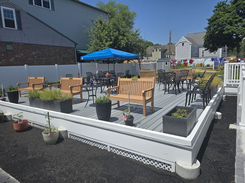 Shaded patio seating in the green space