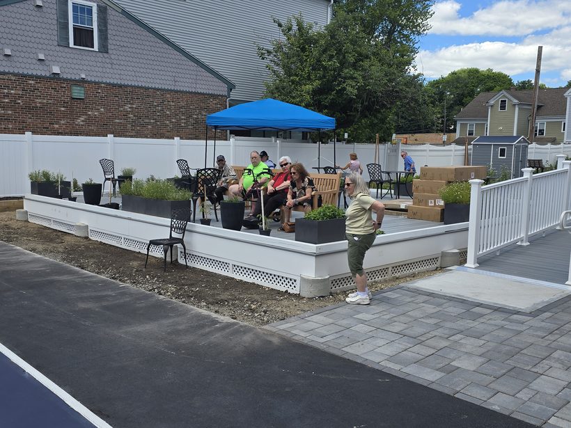 Members gathered on the shaded patio